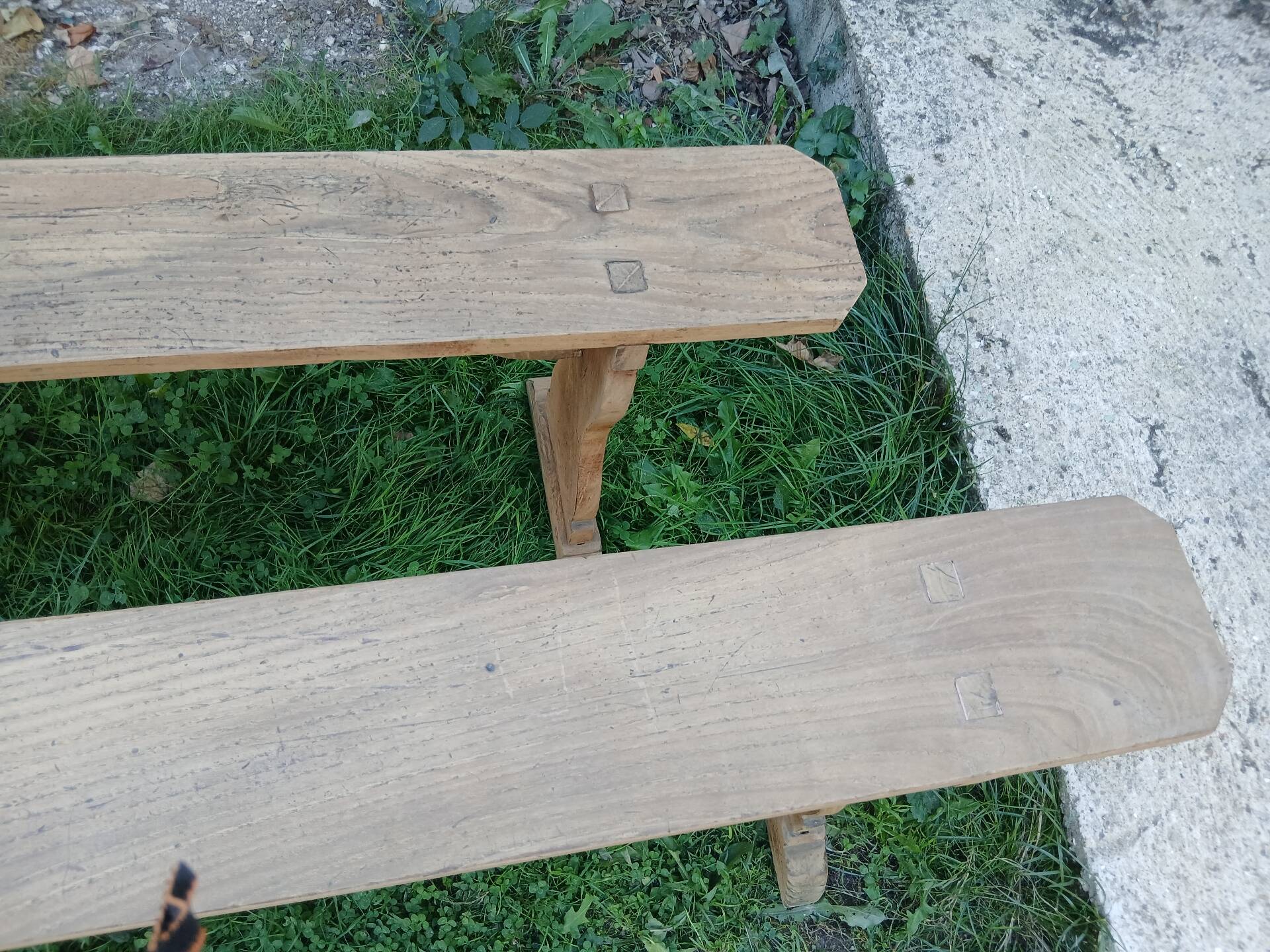 Pairs of large benches in raw fir wood.
