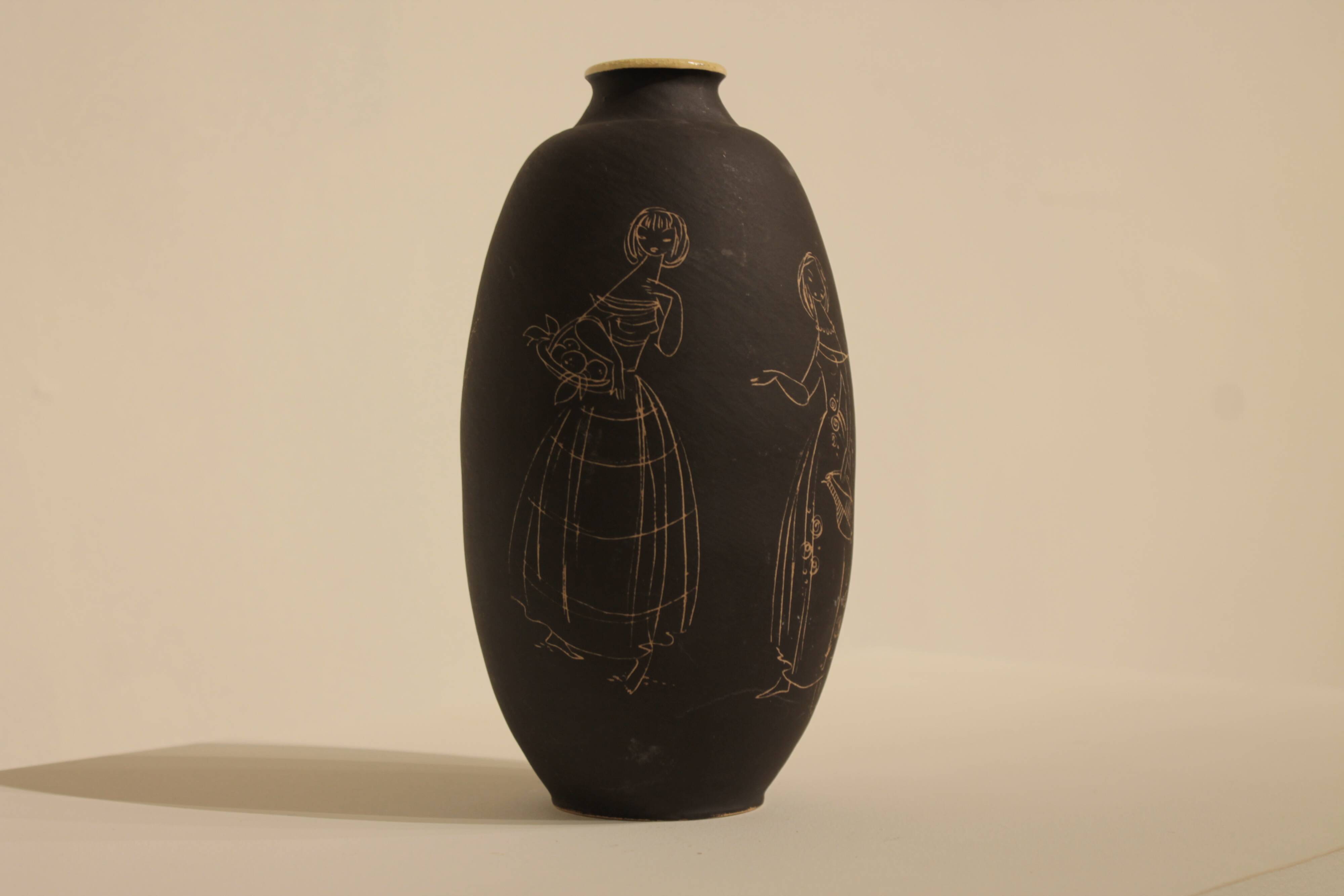 Ceramic vase decorated with women and a tree.