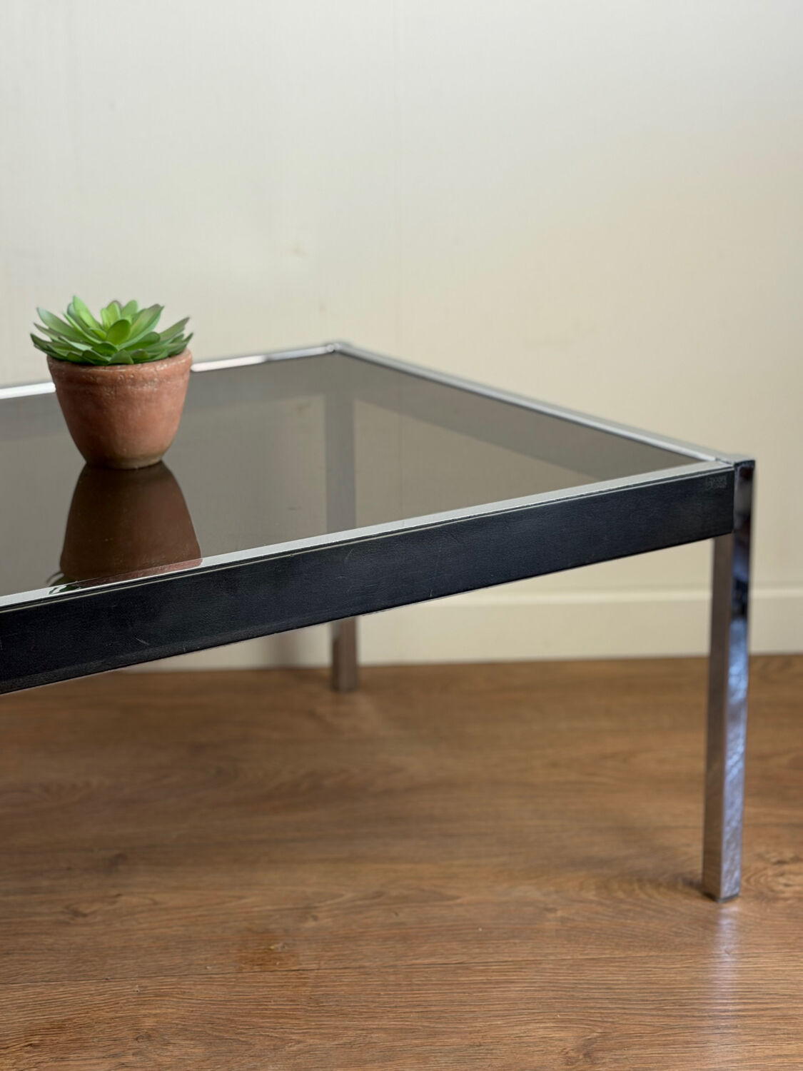 Large designer coffee table from the 70s in chrome, smoked glass, and faux leather.