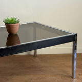Large designer coffee table from the 70s in chrome, smoked glass, and faux leather.