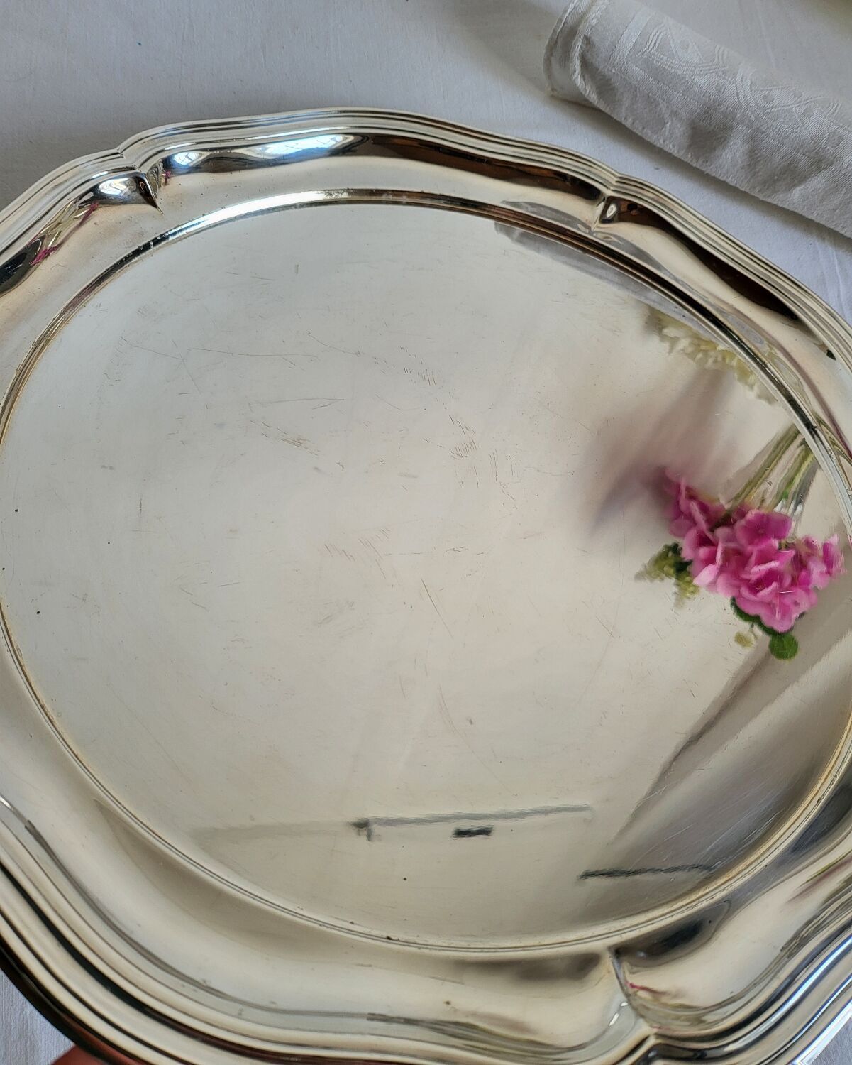 Round silver-plated serving dish with a glass base.