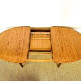Oval teak dining table with extension