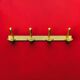Vintage wall-mounted coat rack in anodised gold aluminium – 4 hooks – 1960s
