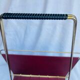 Vintage magazine rack in red skai with gold metal frame and plastic handle