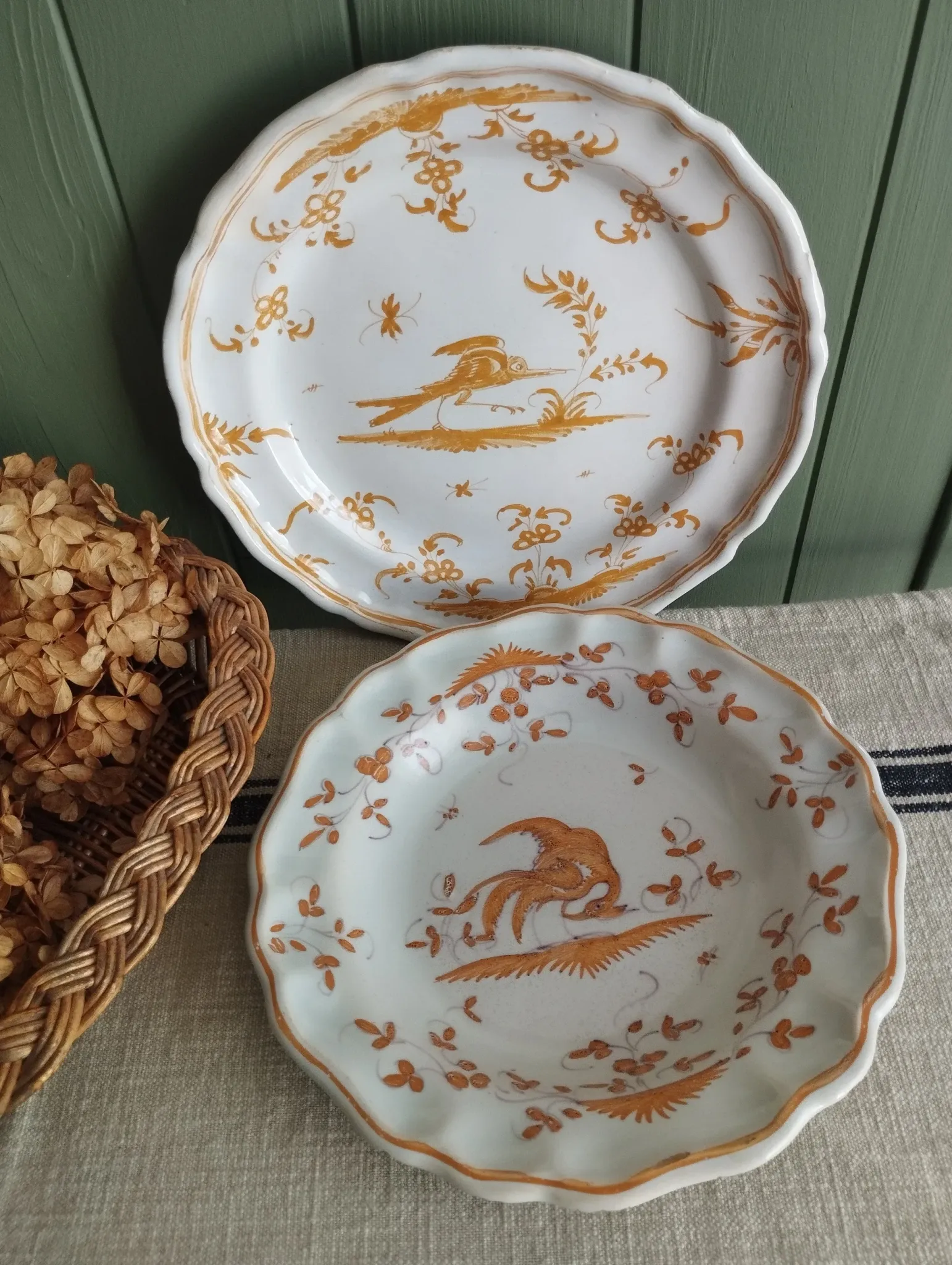 Pair of antique plates with a bird of paradise design in the style of Moustiers.