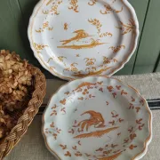 Pair of antique plates with a bird of paradise design in the style of Moustiers.