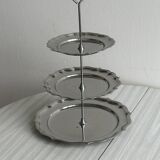 Three-tiered serving trolley in shiny stainless steel.