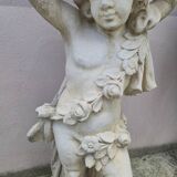 Antique reconstituted stone planter depicting a cherub