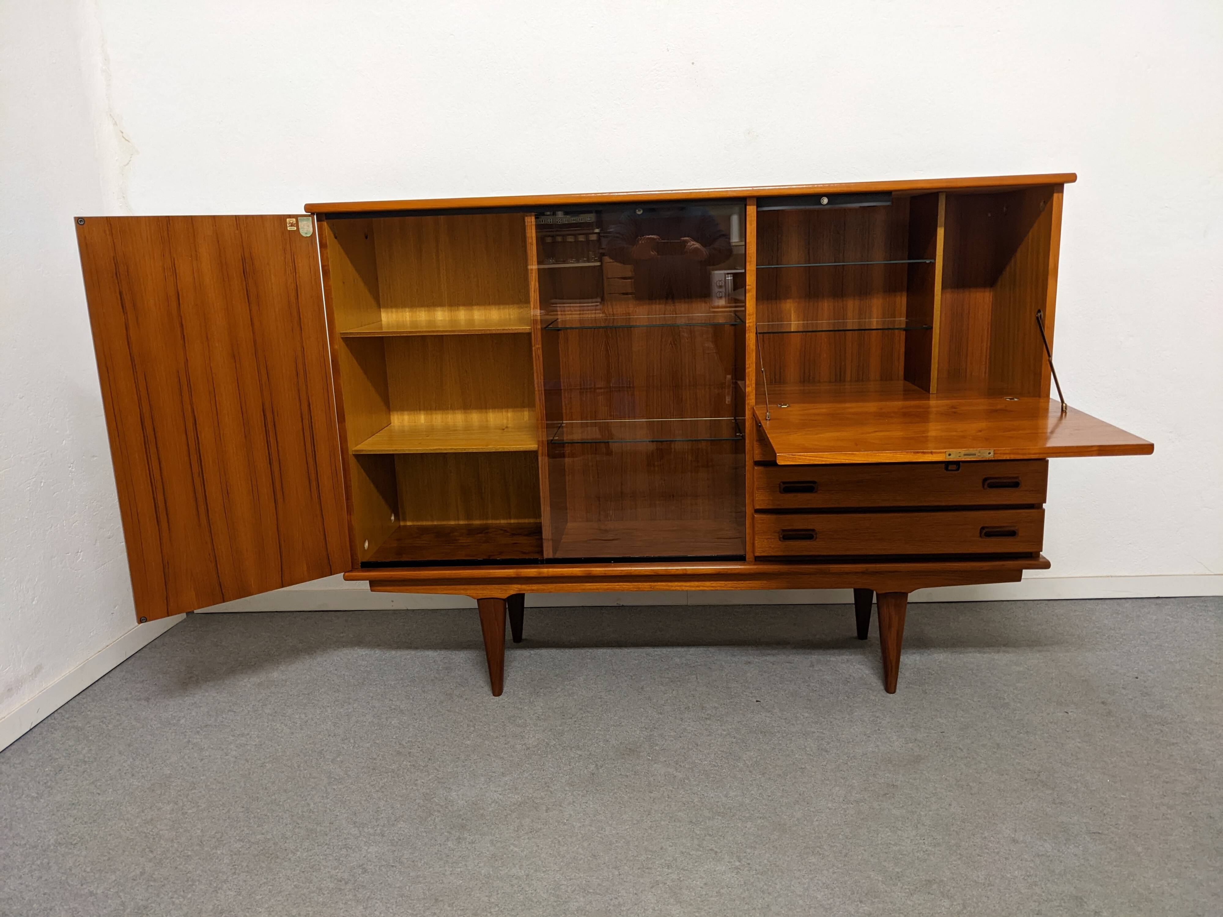 High sideboard, display cabinet and secretary, Scandinavian in teak, France around 1960.