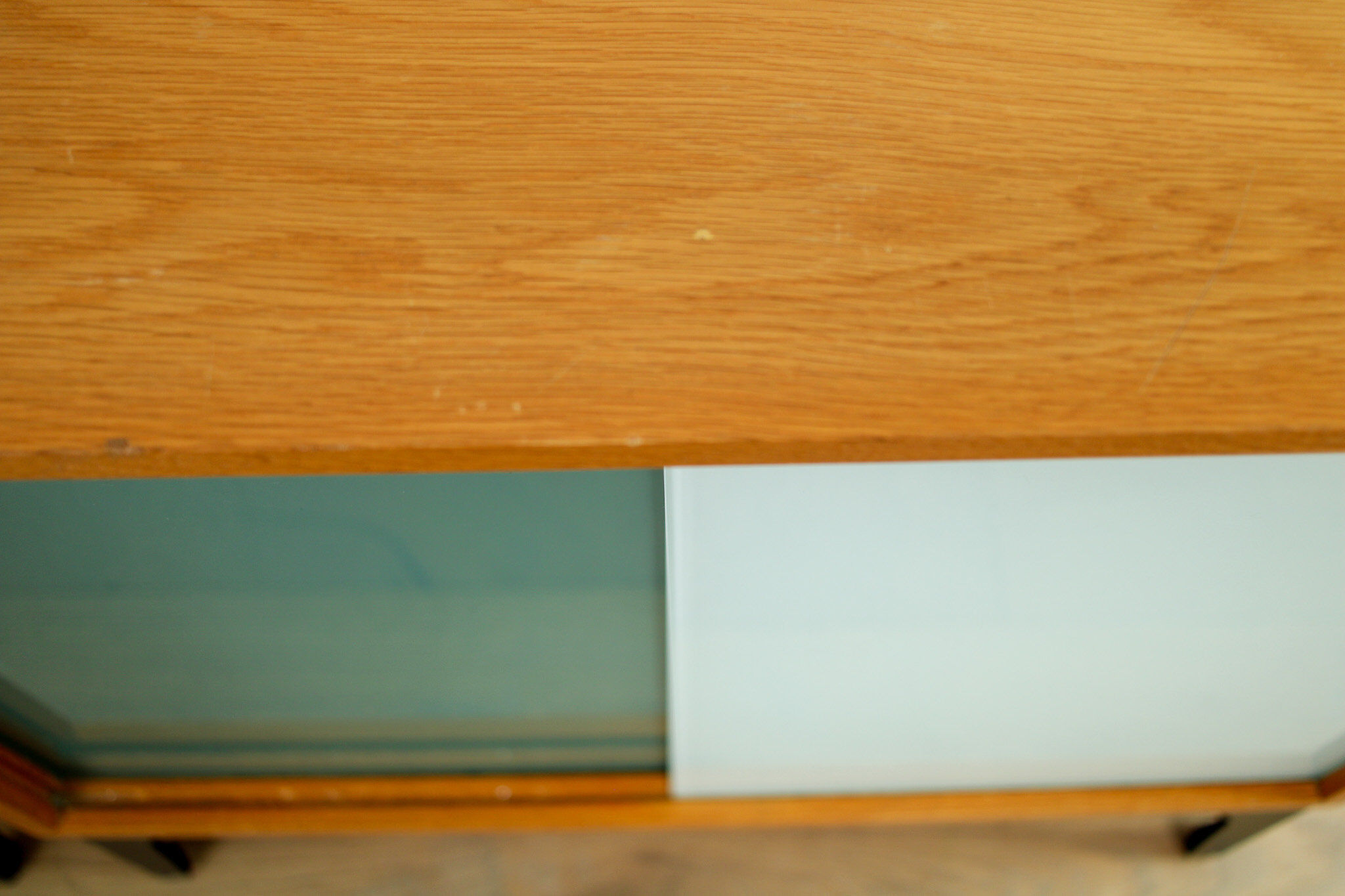 A pair of vintage mid-century bedside tables with glass sliding doors
