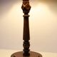 Table lamp with a carved wooden base and pleated lampshade