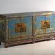Old wooden entrance buffet in blue and yellow tones (circa 1920).