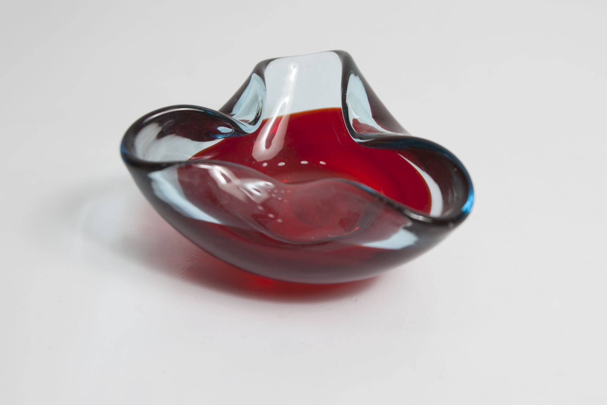Asymmetrical ashtray murano red and transparent background 1960