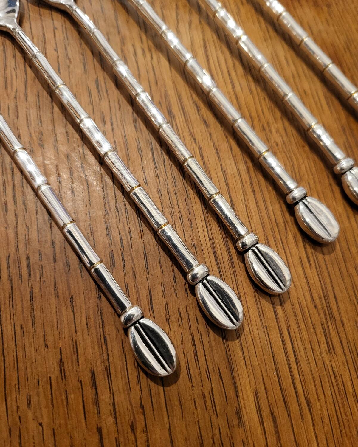 6 long silver-plated metal spoons