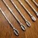 6 long silver-plated metal spoons