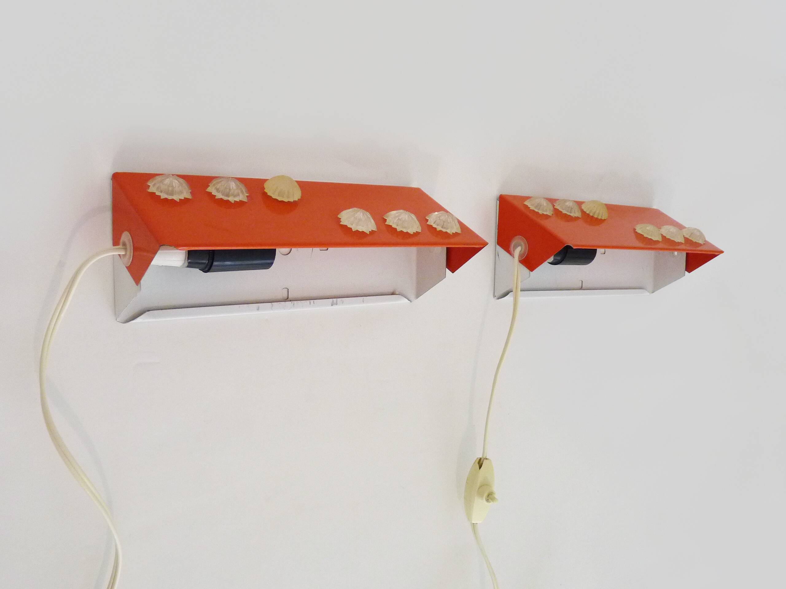 Pair of Scandinavian wall sconces with swivel shade in orange metal. 70