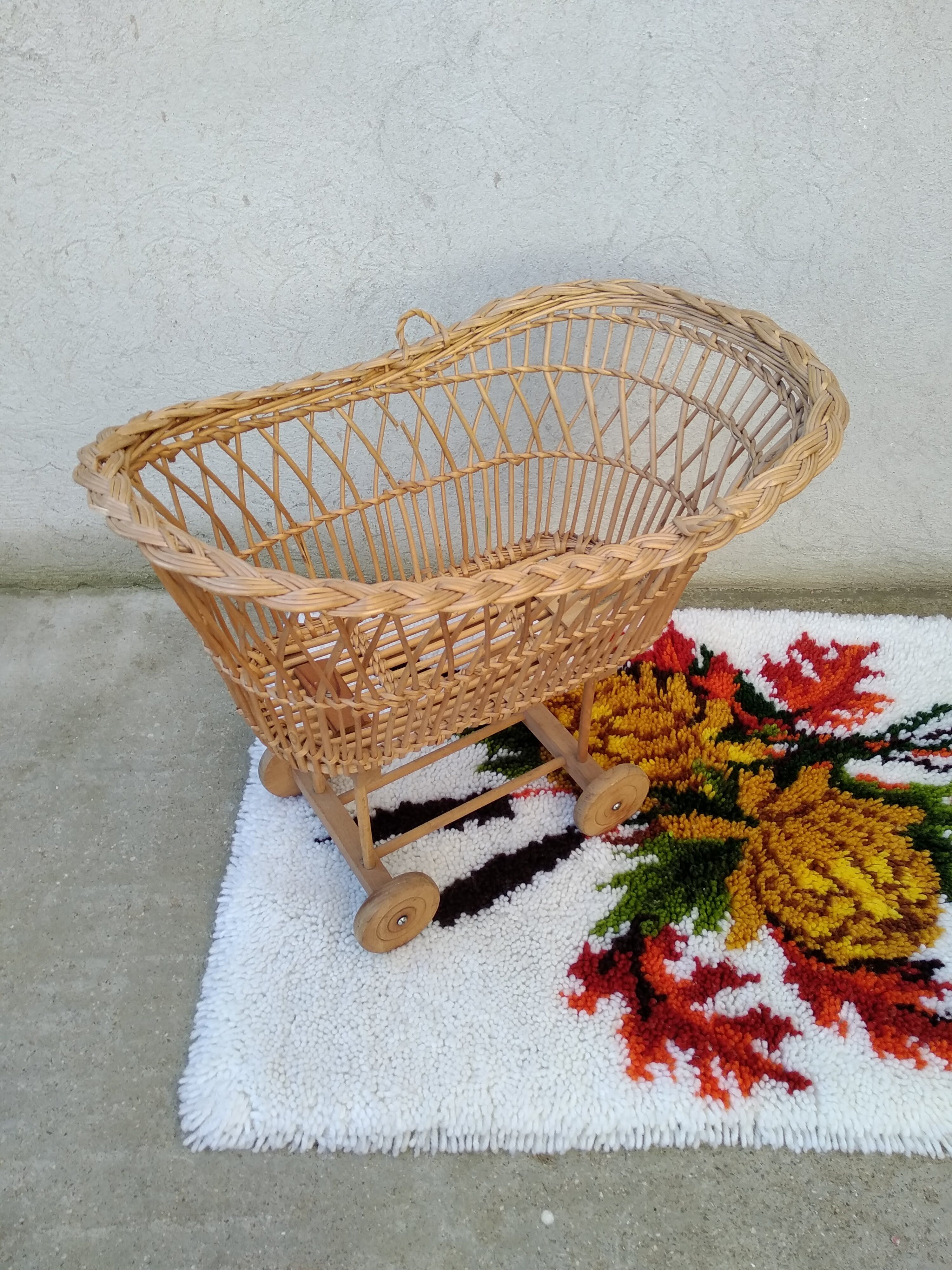 Rattan cradle for doll on vintage wheels