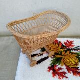 Rattan cradle for doll on vintage wheels