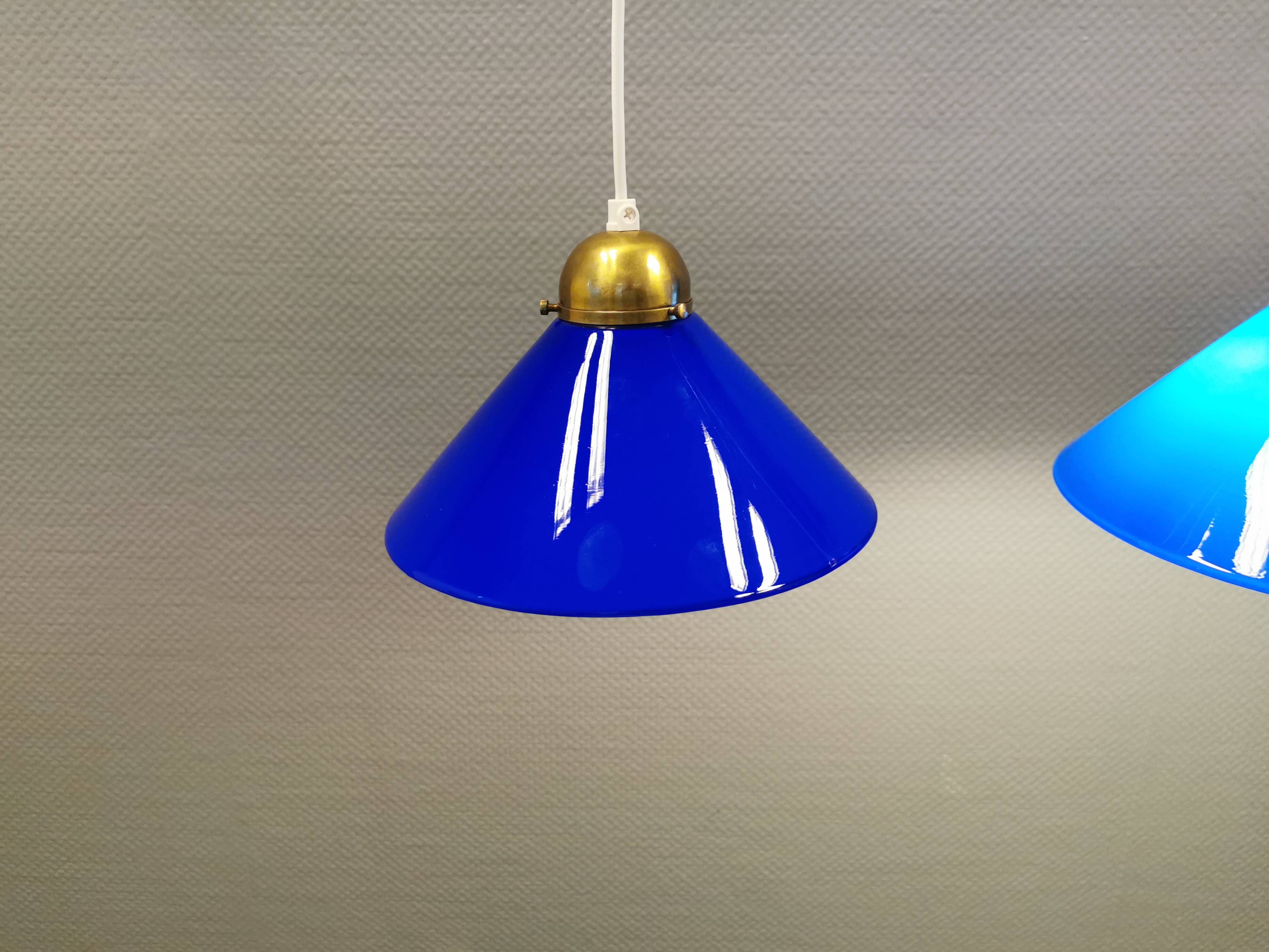Two lamps in double layered glass with brass top. Danish and estimated from the 1960s