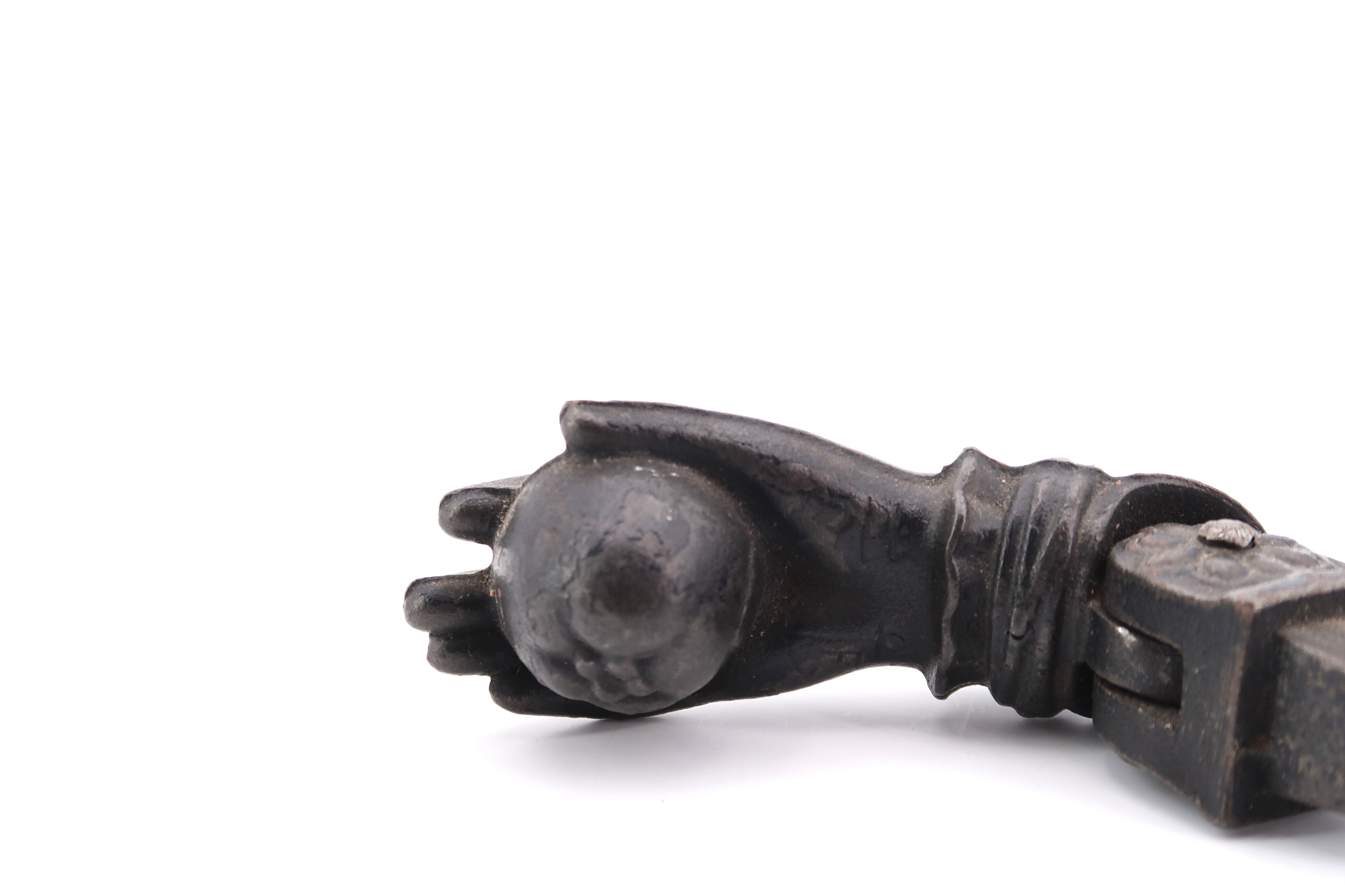 Hand-shaped metal door knocker, 1930s