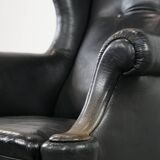 Antique black English cow leather wingback armchair from the 19th century