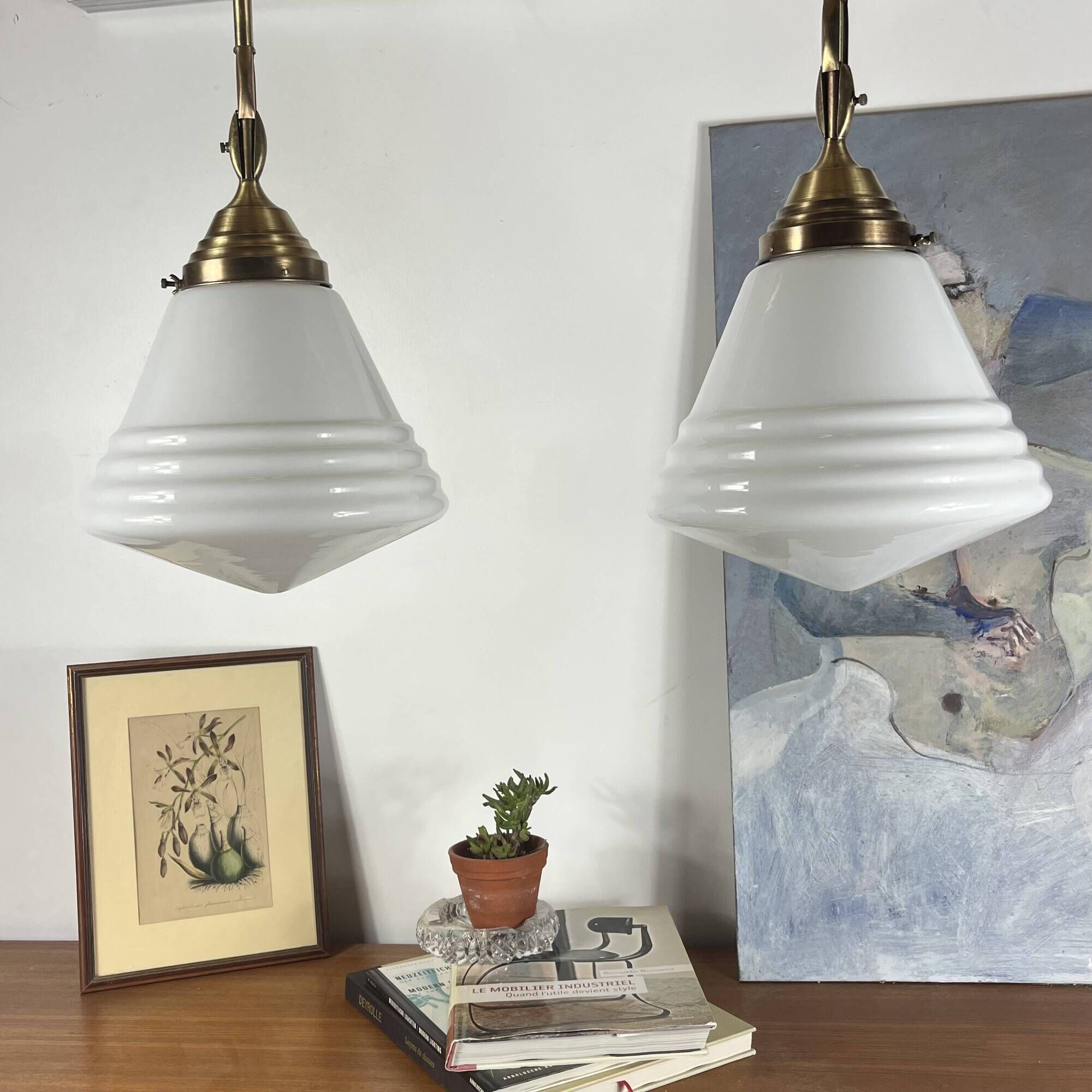 Pair of opaline glass pendant lights in white by Philips and brass from the 1920s.