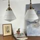 Pair of opaline glass pendant lights in white by Philips and brass from the 1920s.