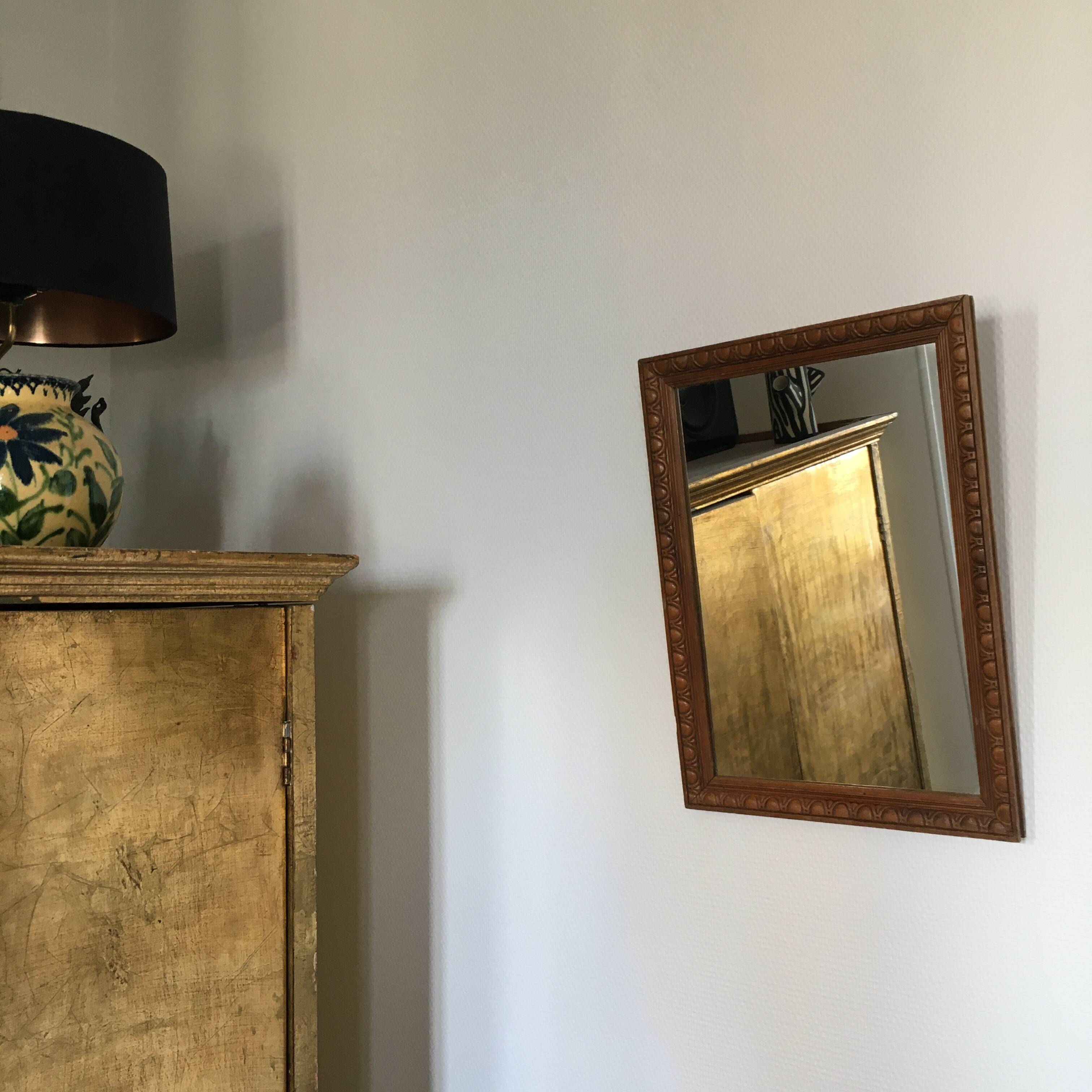 Antique mirror in ornate wood