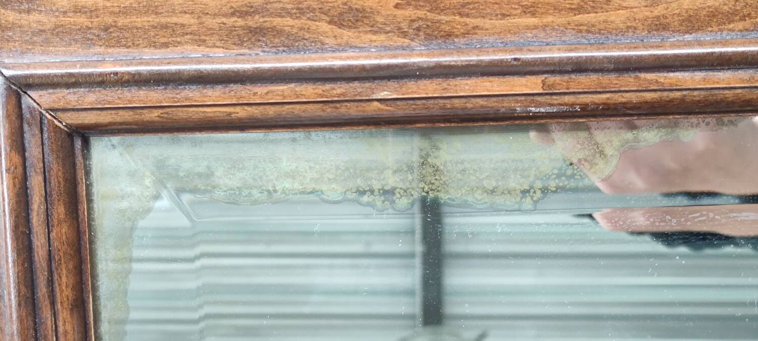 Old beveled mirror with wooden frame