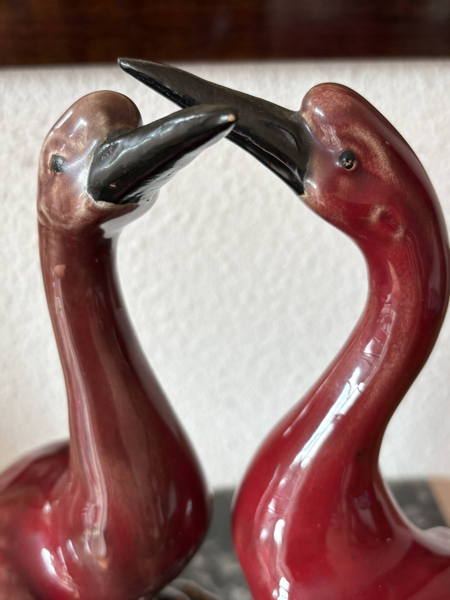 Pair of ceramic red glazed wading bird (crane) figurines.