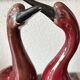 Pair of ceramic red glazed wading bird (crane) figurines.