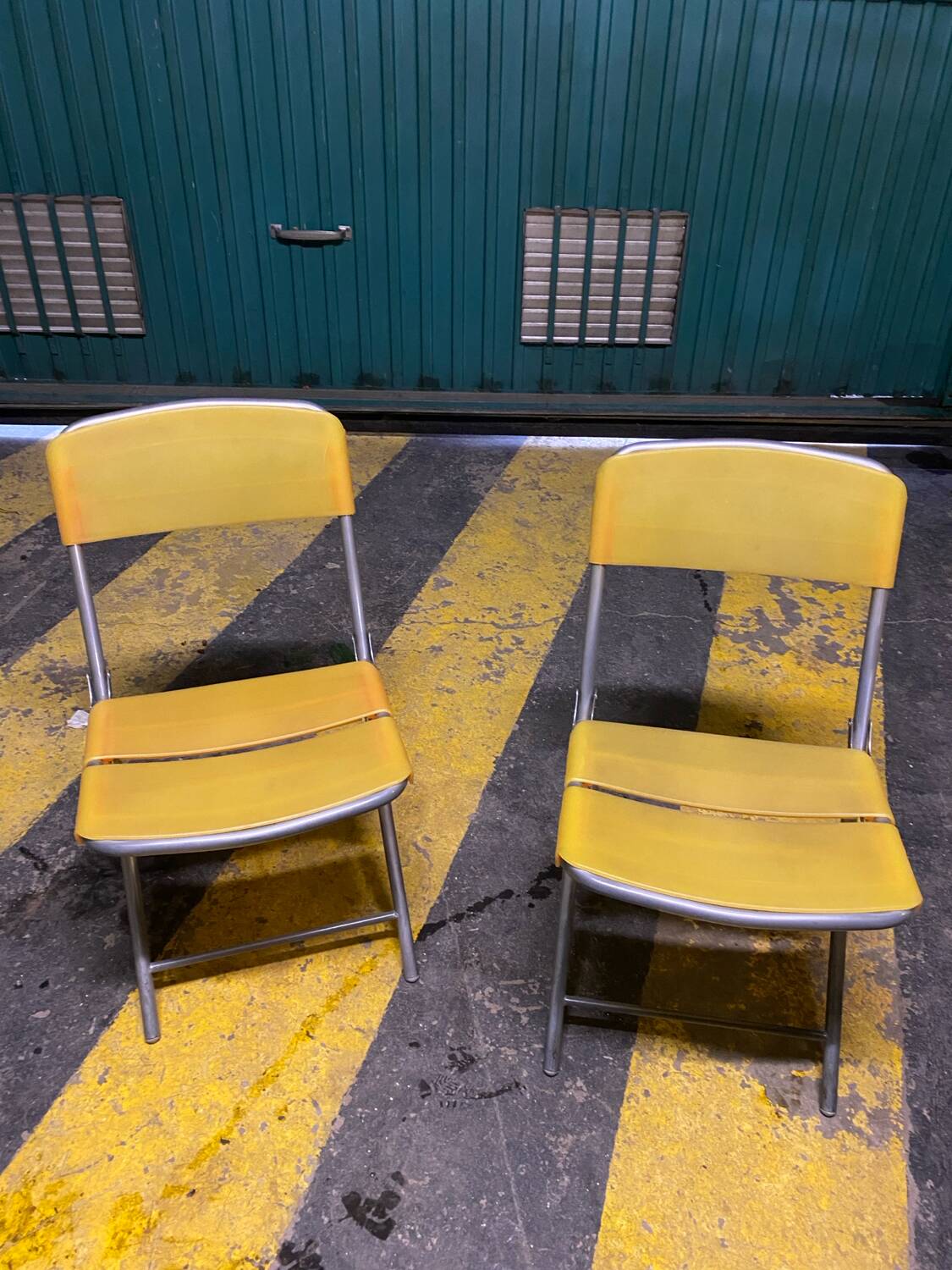 Yellow plastic and steel folding chairs, 1970s