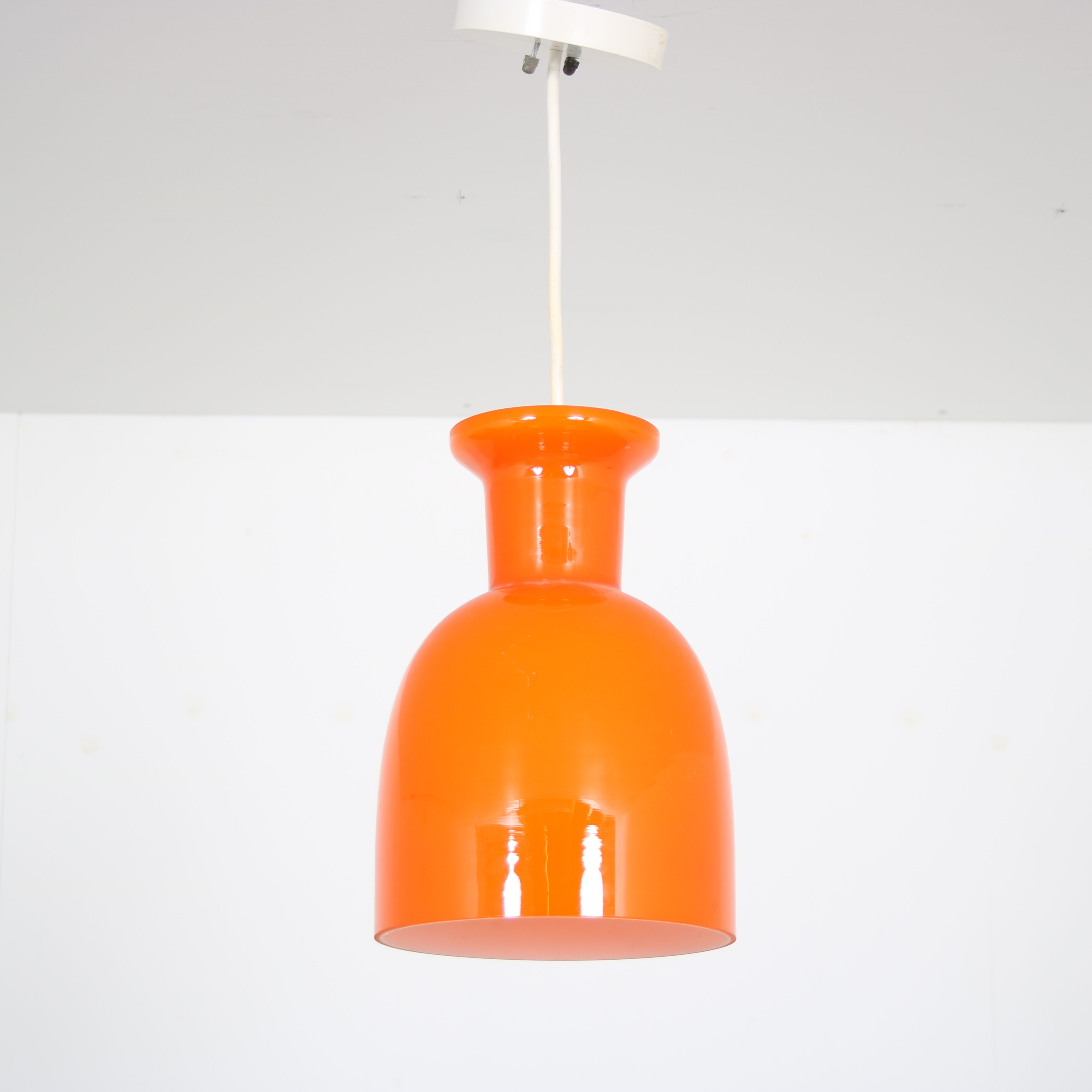 Pair of orange hanging lamps by Raak, the Netherlands, 1970