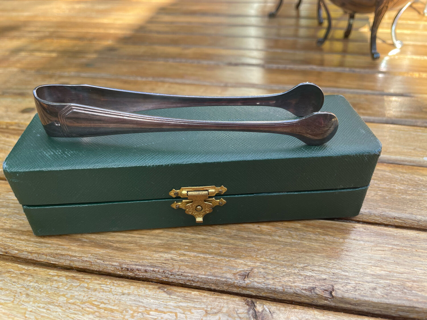 Sugar tongs in silver metal