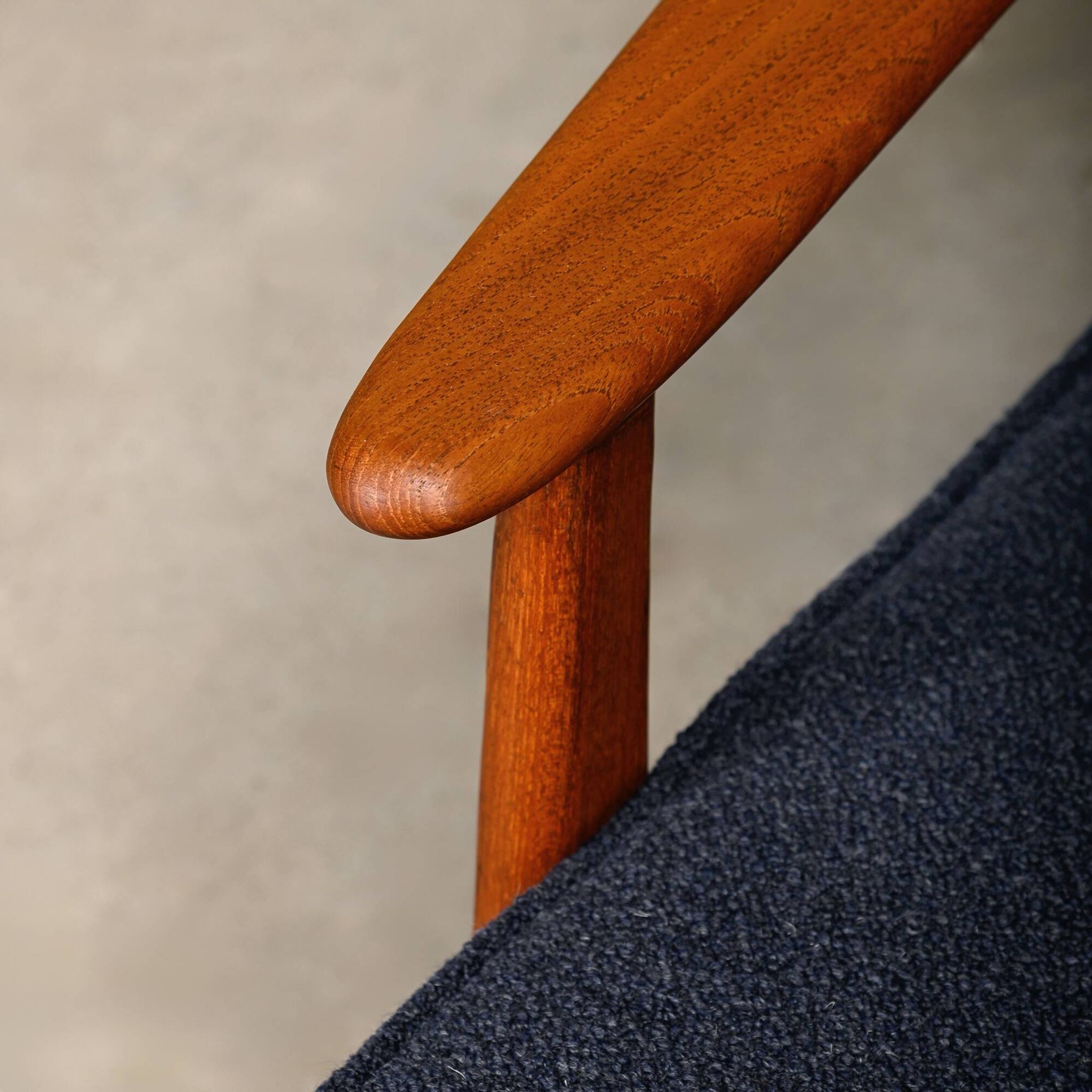Pair Scandinavian Modern armchairs in teak and dark blue bouclé fabric