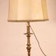 bronze candlestick from the 17th century converted into a lamp with its lampshade