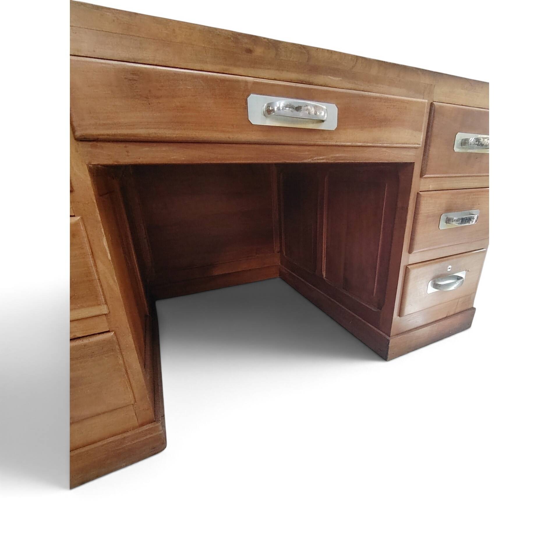 Large modernist minister's desk in solid lemon wood with 7 drawers.