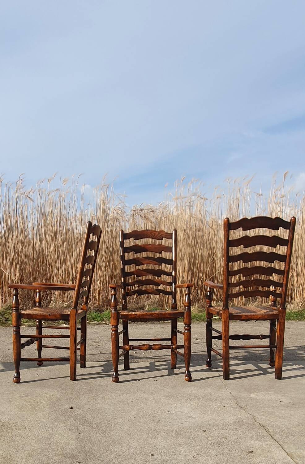 Set of 4 rustic vintage armchairs in English farmhouse style with rush seats.