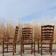 Set of 4 rustic vintage armchairs in English farmhouse style with rush seats.
