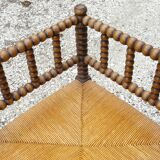 Turned wood straw corner armchair