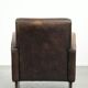 Comfortable sheepskin armchair with matching piping and a timeless look