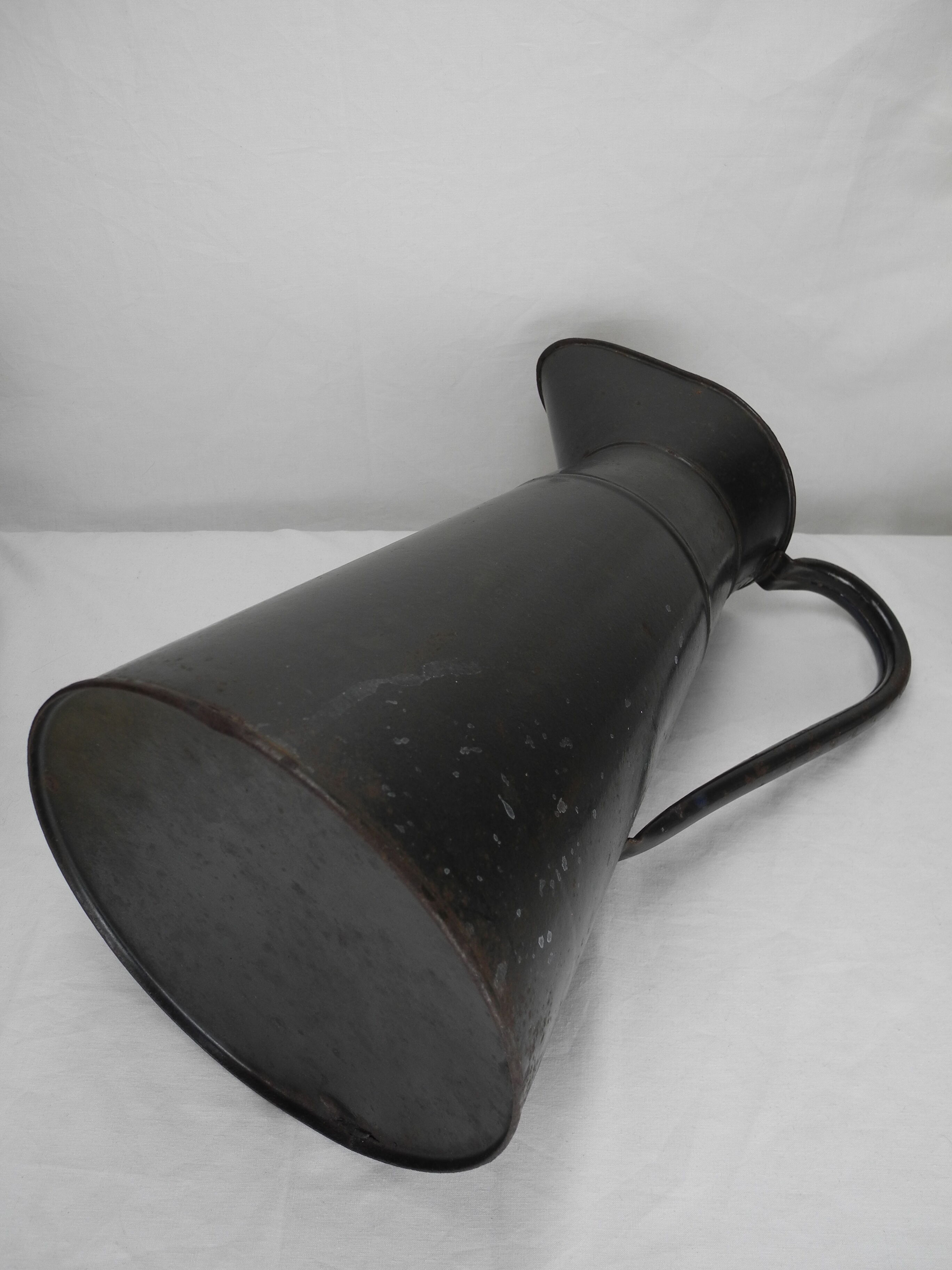Old enamelled sheet metal jug