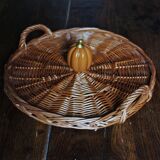 Medium round dark wicker plateau with two handles.