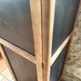 Vintage wooden wardrobe with matte cast iron color hanging rail