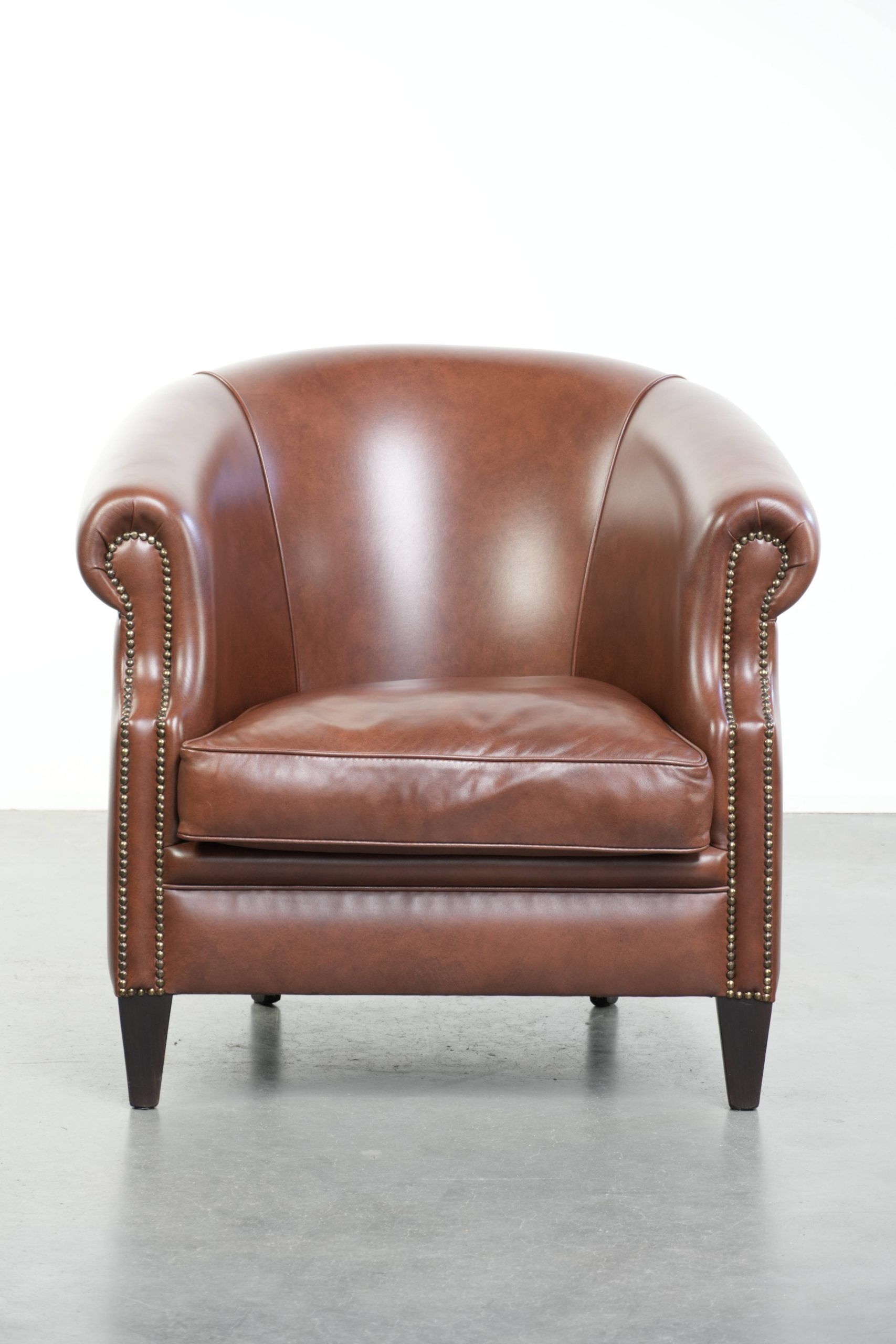 Cognac-coloured comfortable cow leather club armchair in English style