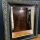 19th-century mirror Napoleon III in blackened wood on a gold background.