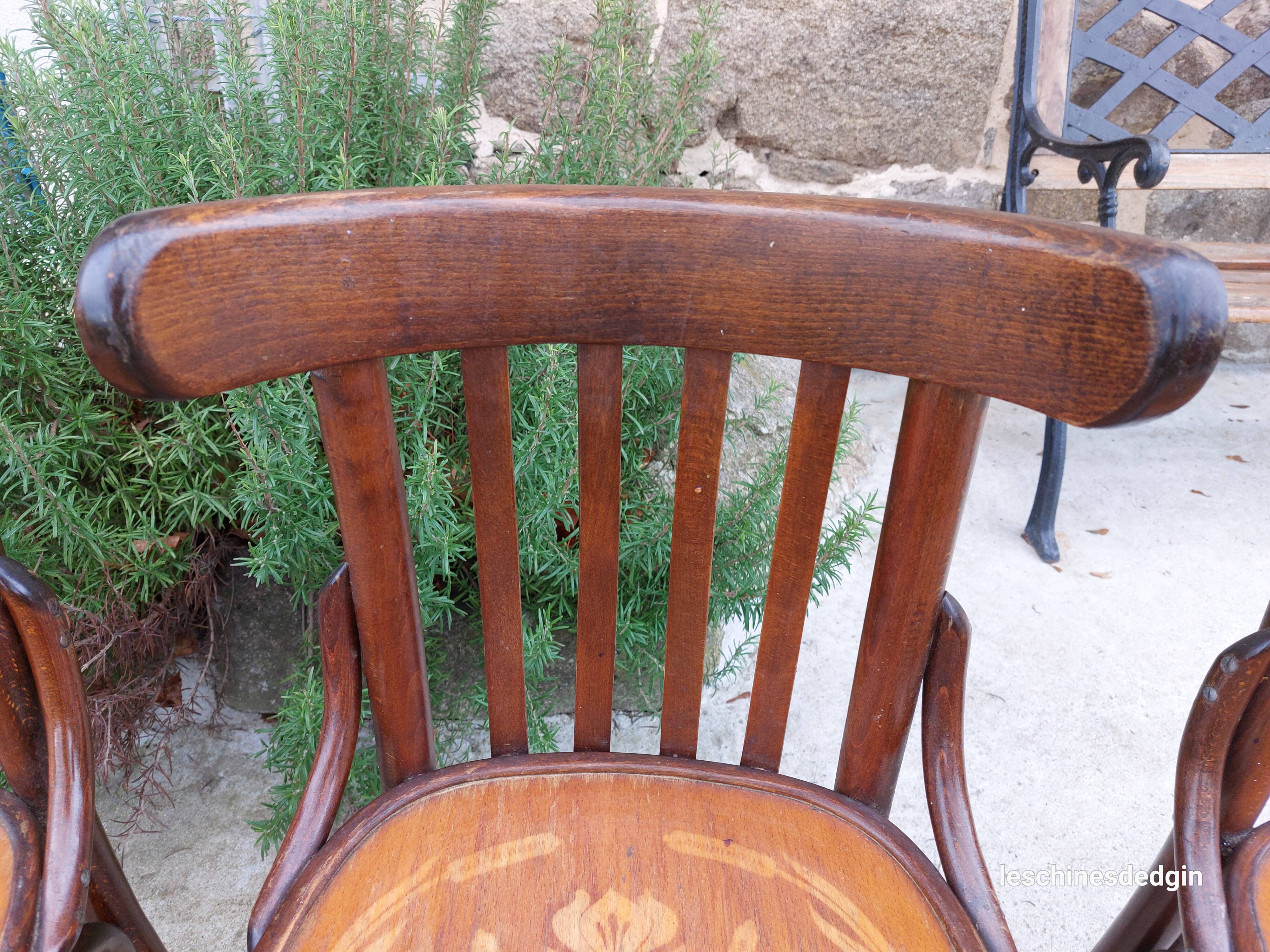 4 bentwood bistro chairs with a pattern on the seat