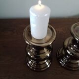 Two bronze-colored candlesticks
