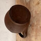 Ancient pitcher in earth