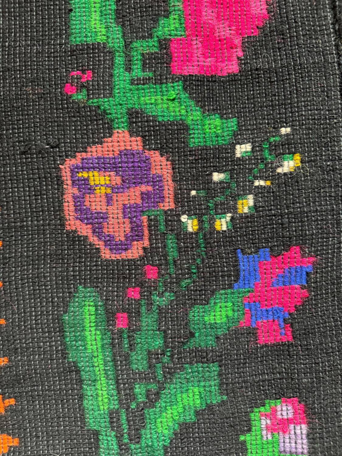 Romanian black wool carpet with a basket of colorful flowers